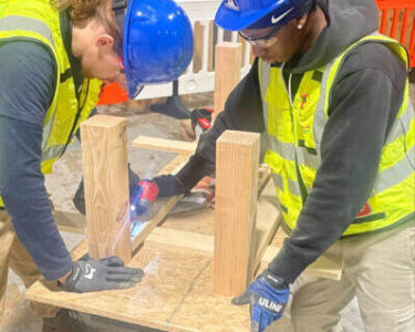 TACC two young men building a wood project in a